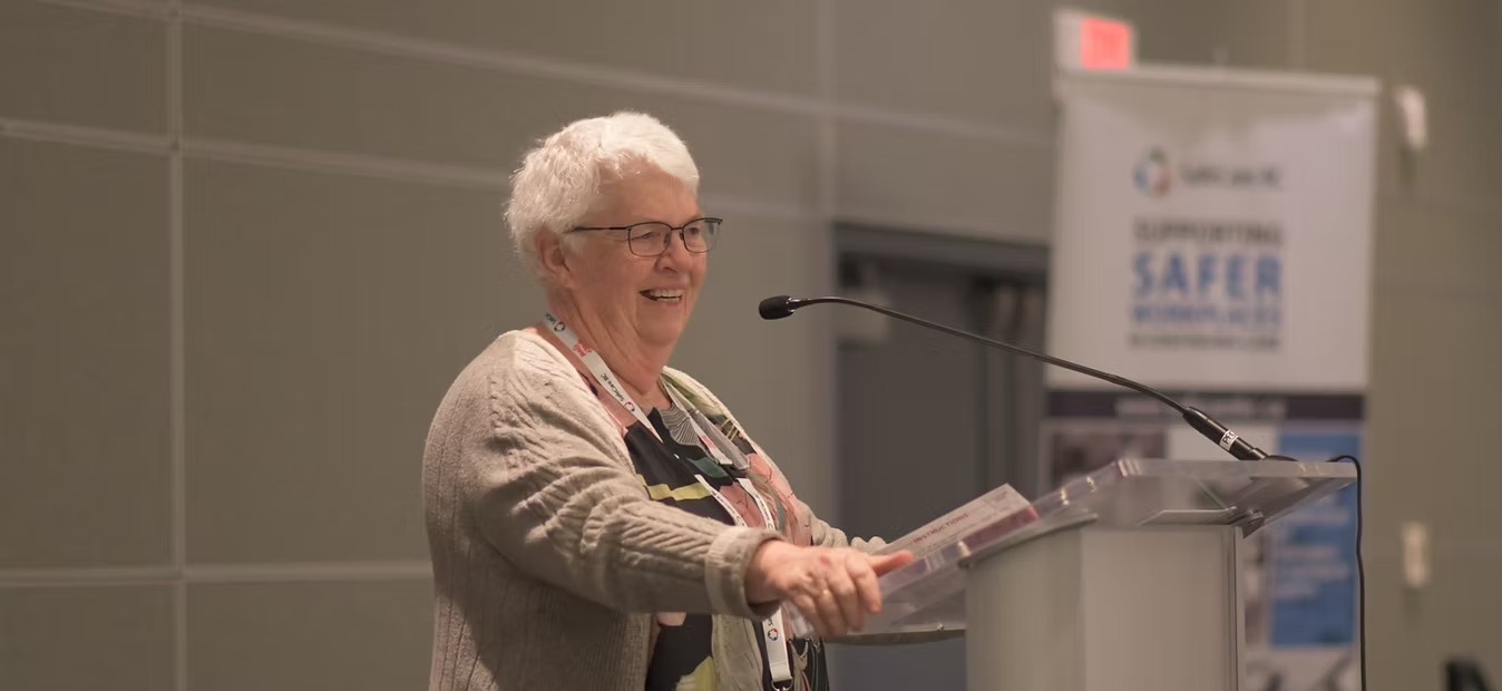 Brenda Robinson speaking at a podium